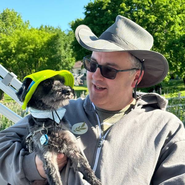 My dog Auggie and I in a boat wearing hats